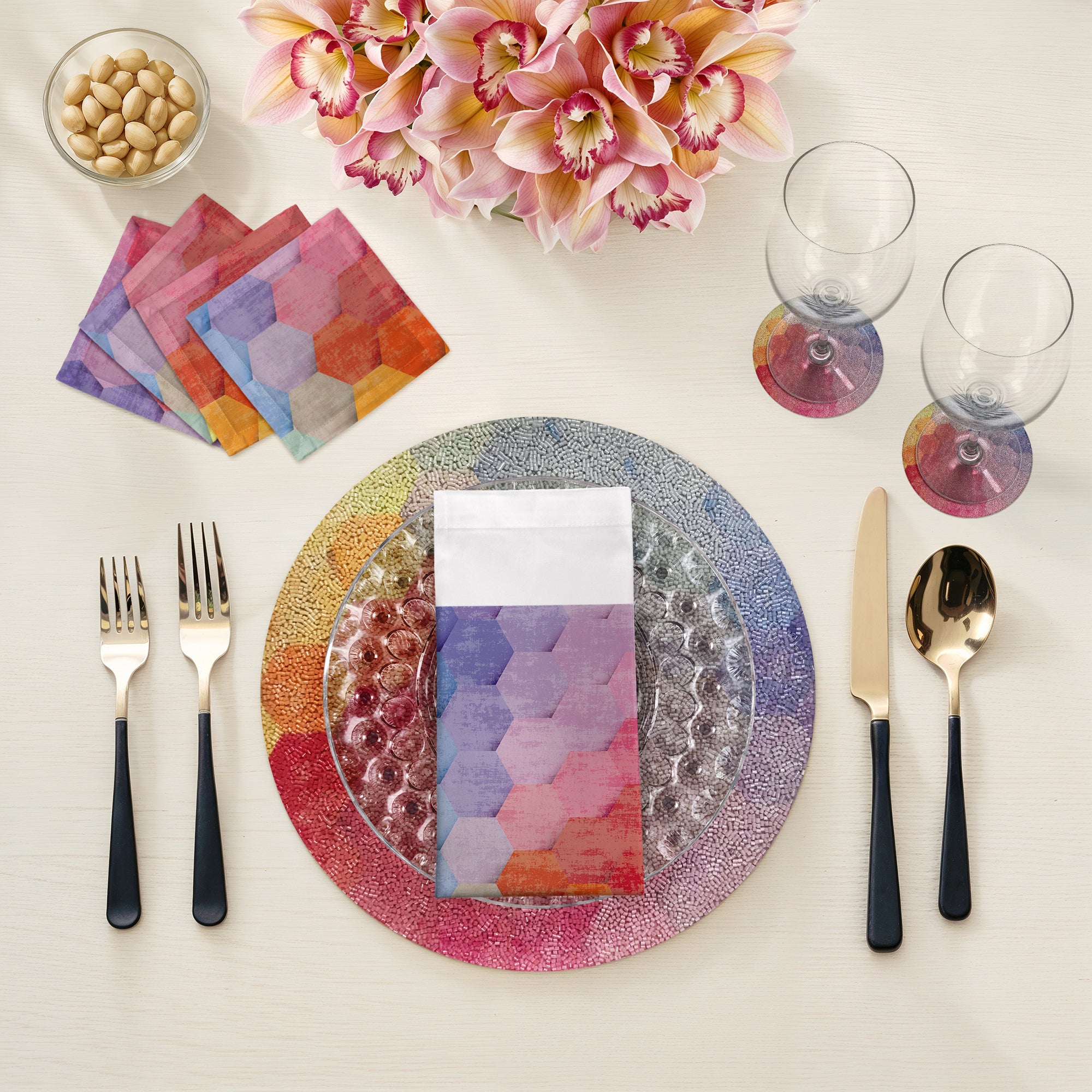 Colorful table setting with a plate, cutlery, and napkins on a white surface.