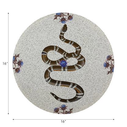 Round decorative item with a snake design on a white background